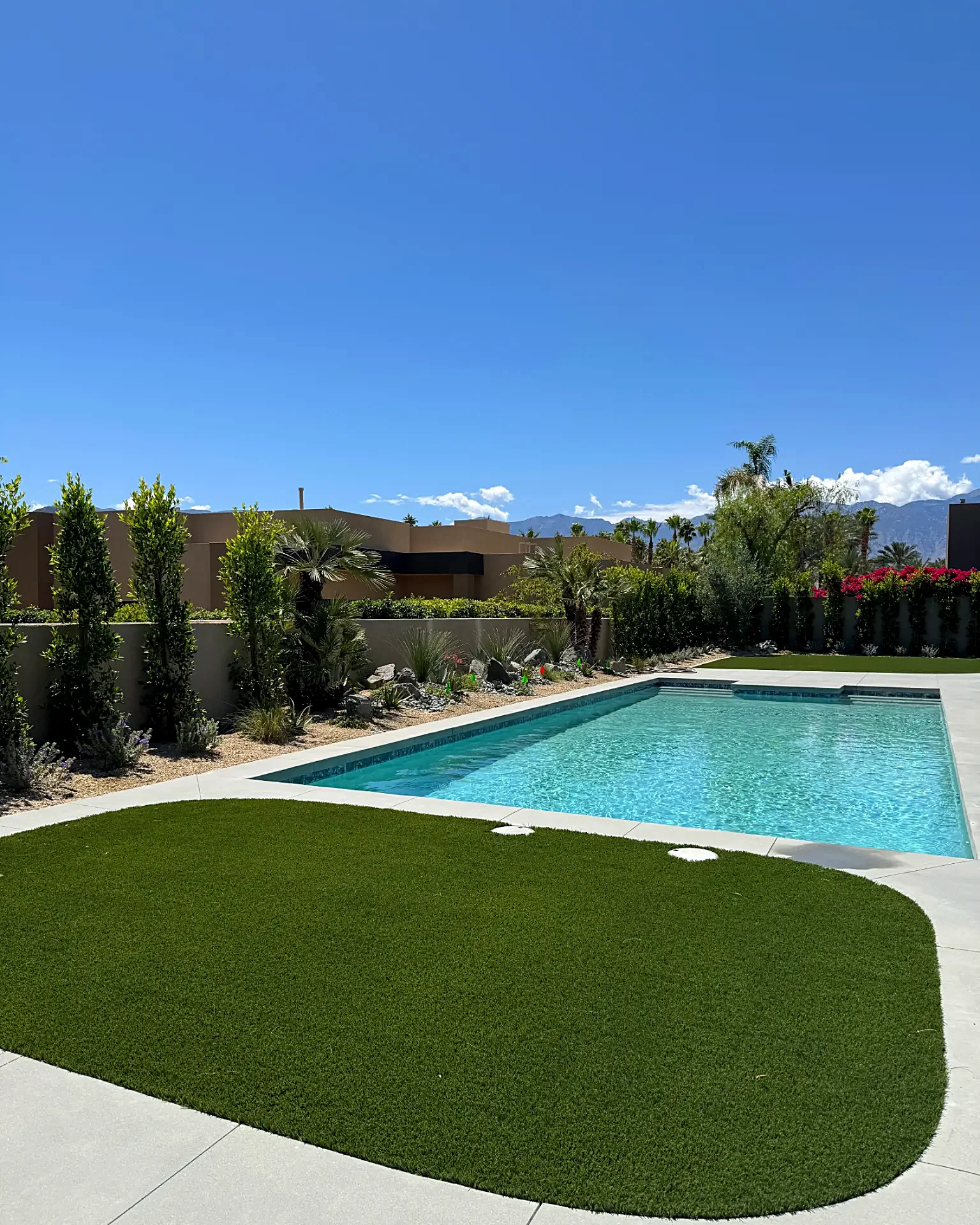 Pool, concrete deck and curved turf lawn